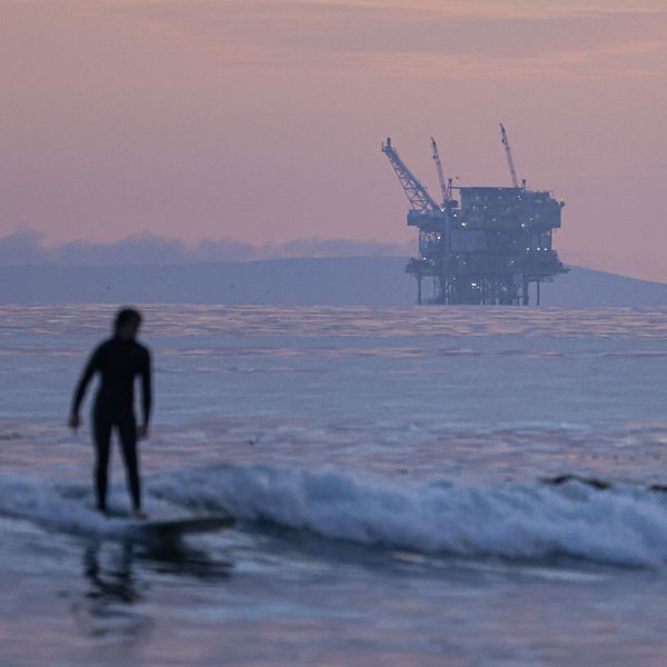 surfer and Santa Barbara oil platform