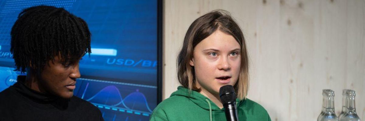 Swedish activist Greta Thunberg (R) speaks next to Ugandan activist Vanessa Nakate (L) on the sideline of the World Economic Forum annual meeting in Davos, Switzerland on January 19, 2023.