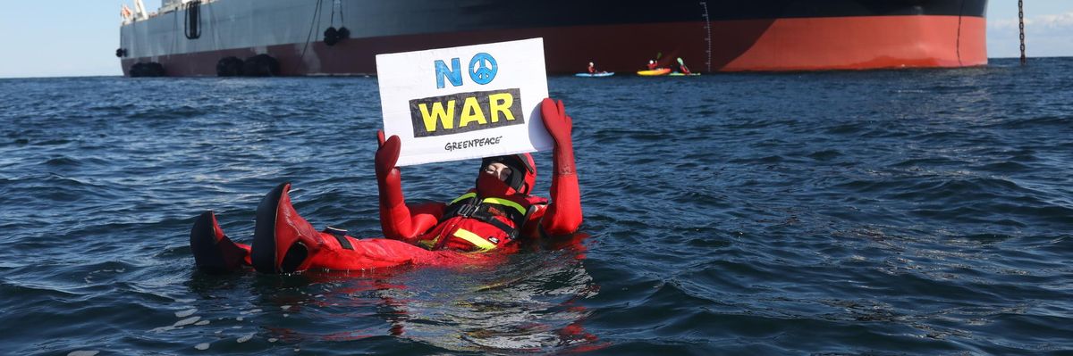 Swimmers and kayakers attempt to block a Russian tanker transporting oil in Danish waters on March 31, 2022.