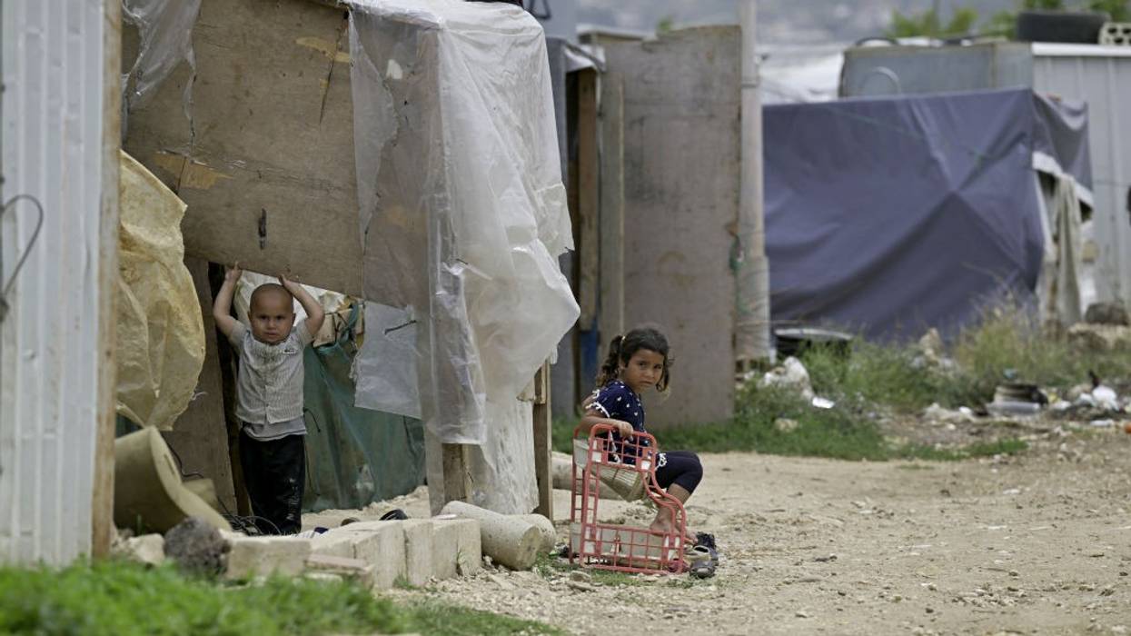 Syrian children play outside their family's tent