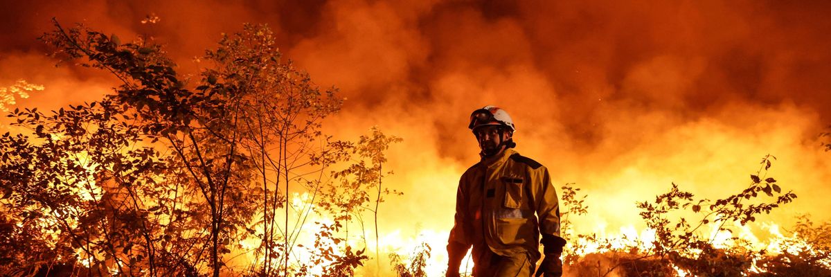 Tactical firefighters work to prevent a wildfire from spreading further as the winds change in Louchats, France on July 17, 2022.