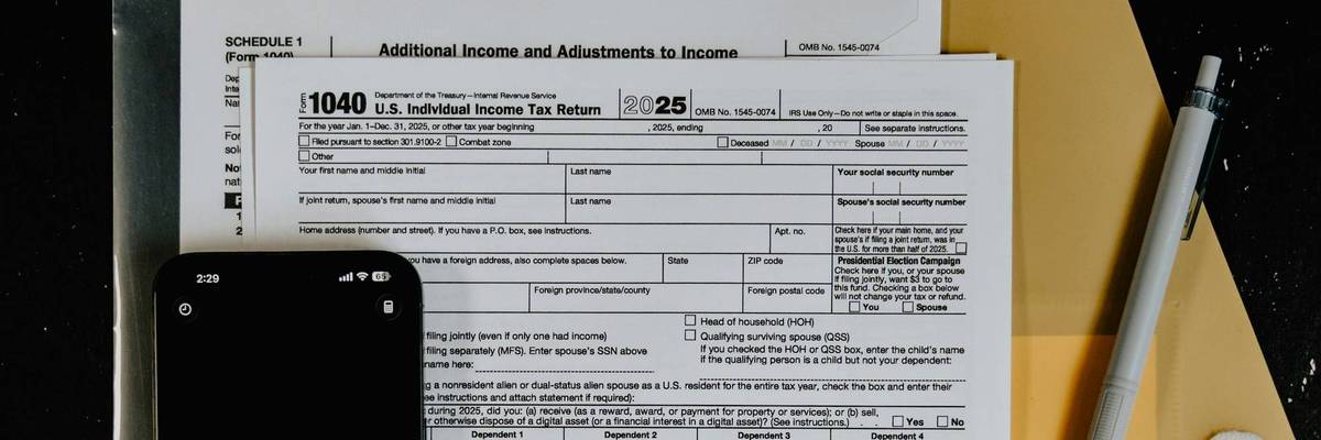 Tax forms with calculator and pen