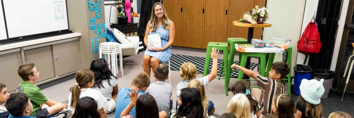 Teacher talks with students on their first day of third grade