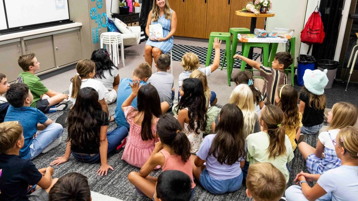 Teacher talks with students on their first day of third grade