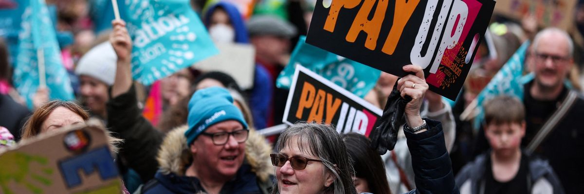 Teachers hold placards during a demonstration