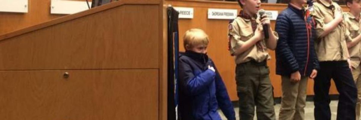 Ten-year-old Liam Holmes of Durham, North Carolina knelt in protest