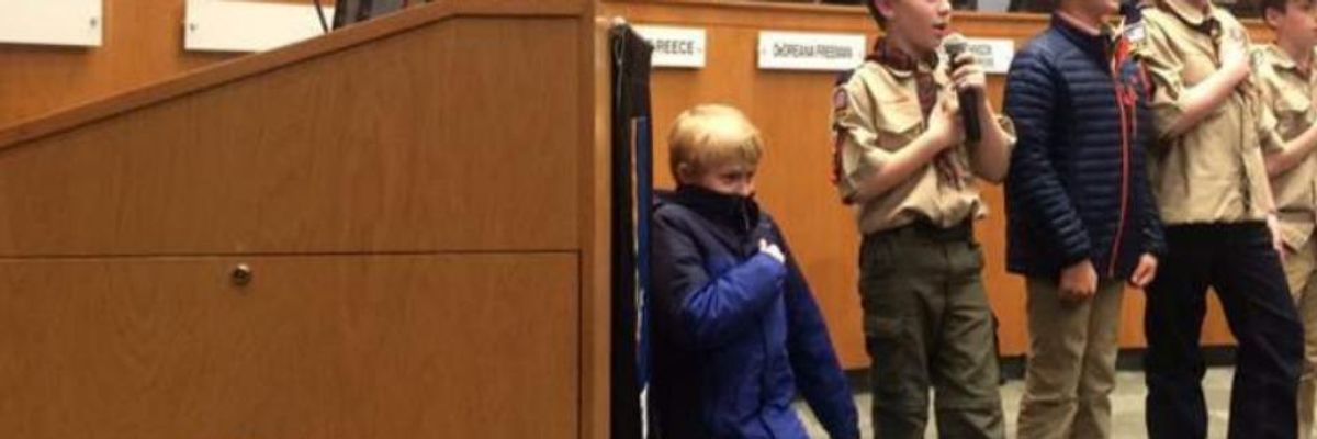 Ten-year-old Liam Holmes of Durham, North Carolina knelt in protest 