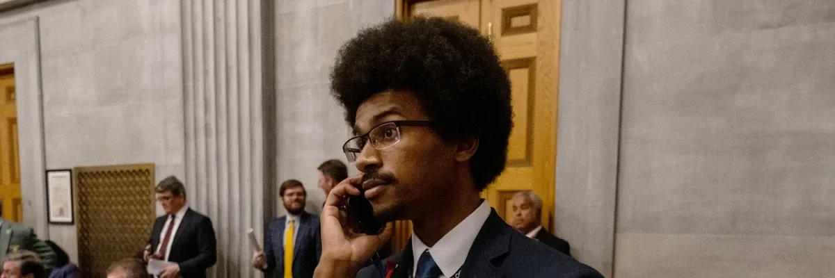Tennessee Rep. Justin Pearson (D-86) speaks on his phone while being expelled from the state Legislature on April 6, 2023 in Nashville. ​
