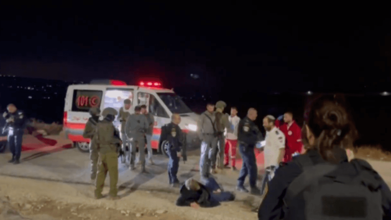 The activist Andrey X is seen on the ground after being attacked by Israeli settlers