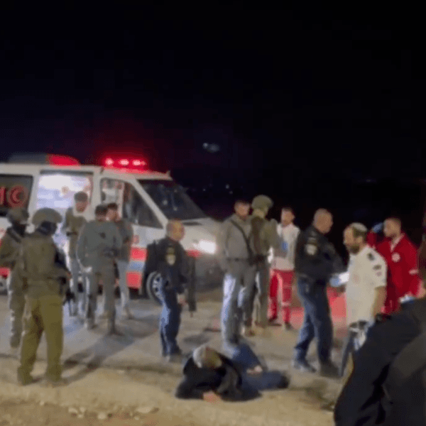 The activist Andrey X is seen on the ground after being attacked by Israeli settlers