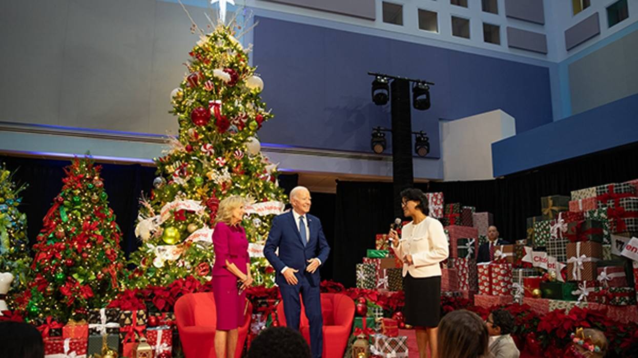 The Bidens stand in front of a Christmas tree.