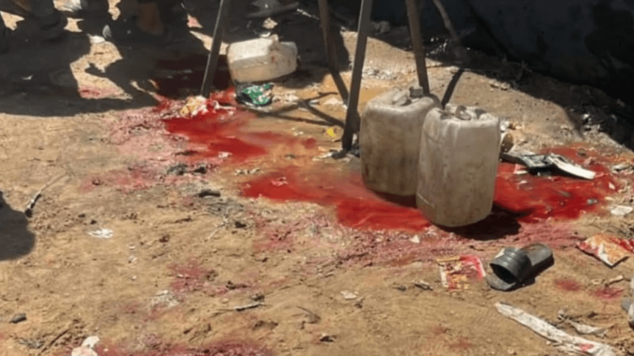the bloody aftermath of an Israeli massacre of people collecting water