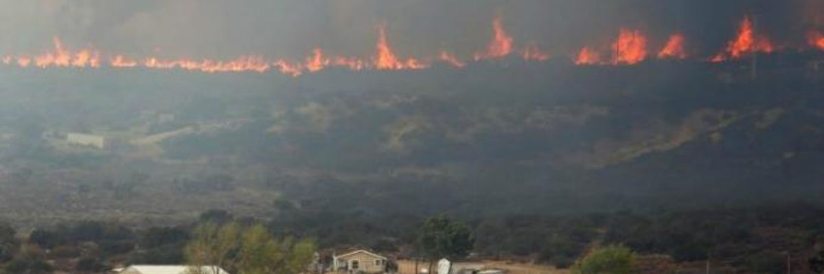The Blue Cut fire burns near a residential area in Phelan, California 
