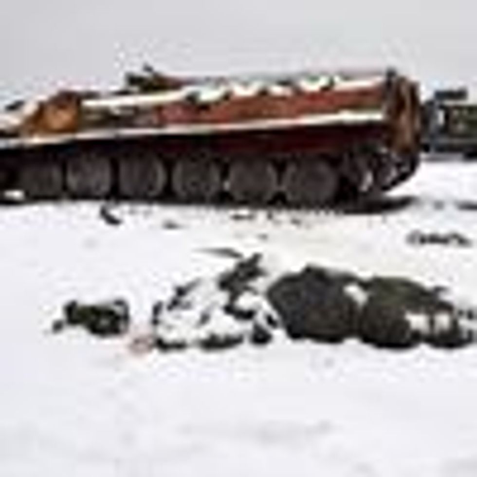 The body of a dead Russian soldier lies near destroyed military vehicles on the outskirts of Kharkiv, Ukraine on February 26, 2022.