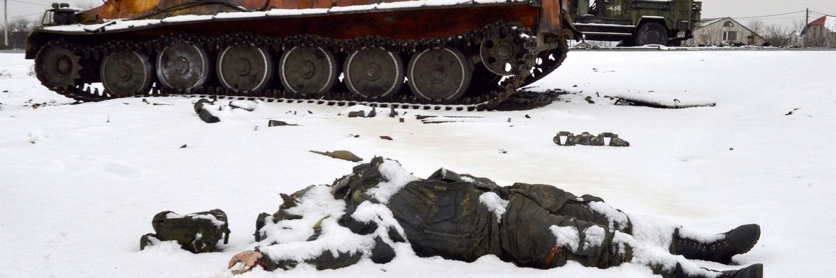 The body of a dead Russian soldier lies near destroyed military vehicles on the outskirts of Kharkiv, Ukraine on February 26, 2022.
