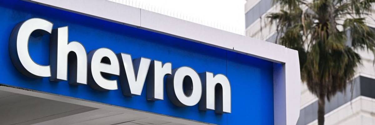 The Chevron logo in white on blue at a gas station.