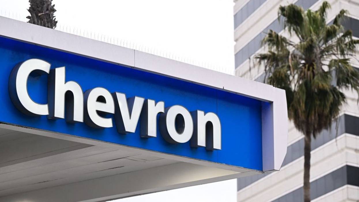 The Chevron logo in white on blue at a gas station.