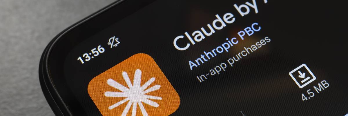 The Claude by Anthropic app logo appears on the screen of a smartphone.