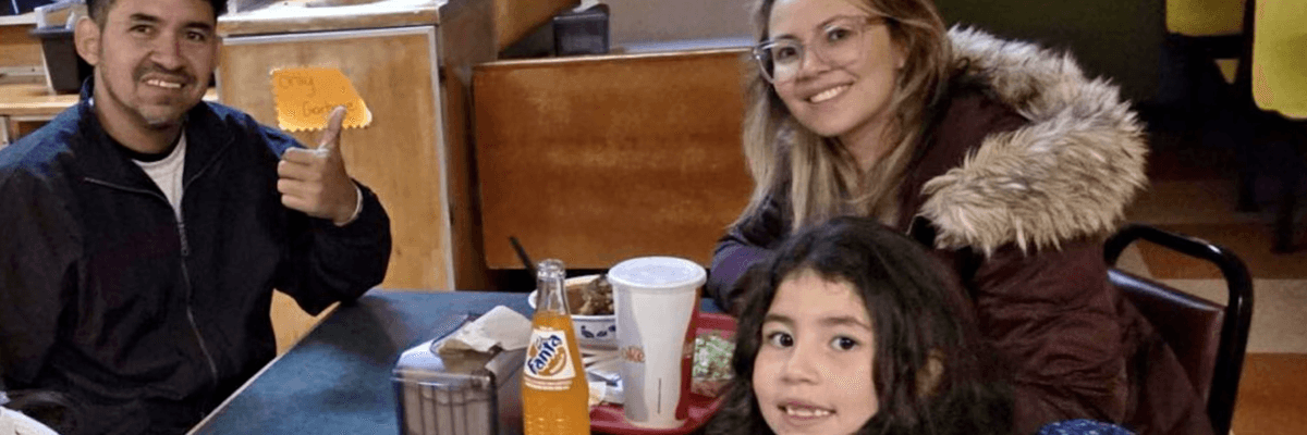 The Crespo-Gonzalez family—father Yohendry, mother Liseth, and 7-year-old Diana—pose for a photo