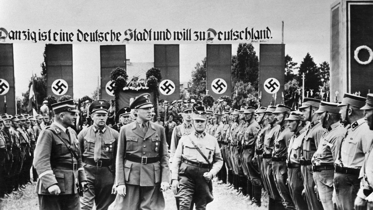 The Danzig district leader of the Nazi party, Albert Foerster reviews local Nazis standing in formation and wearing uniforms shortly before Hitler invaded Poland in 1939.