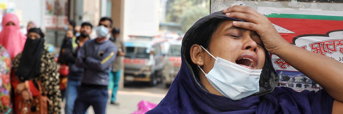 The daughter of a Covid-19 patient cries outside of a hospital