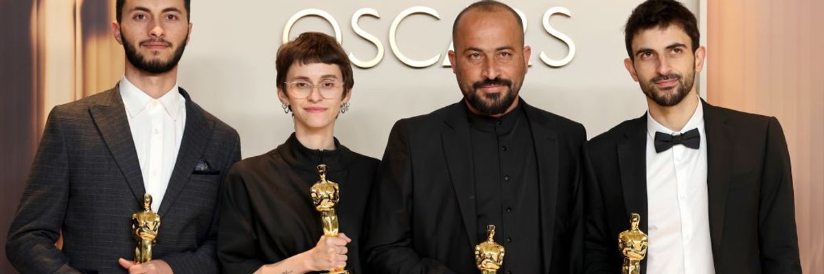 The four co-directors of 'No Other Land' hold their Oscars