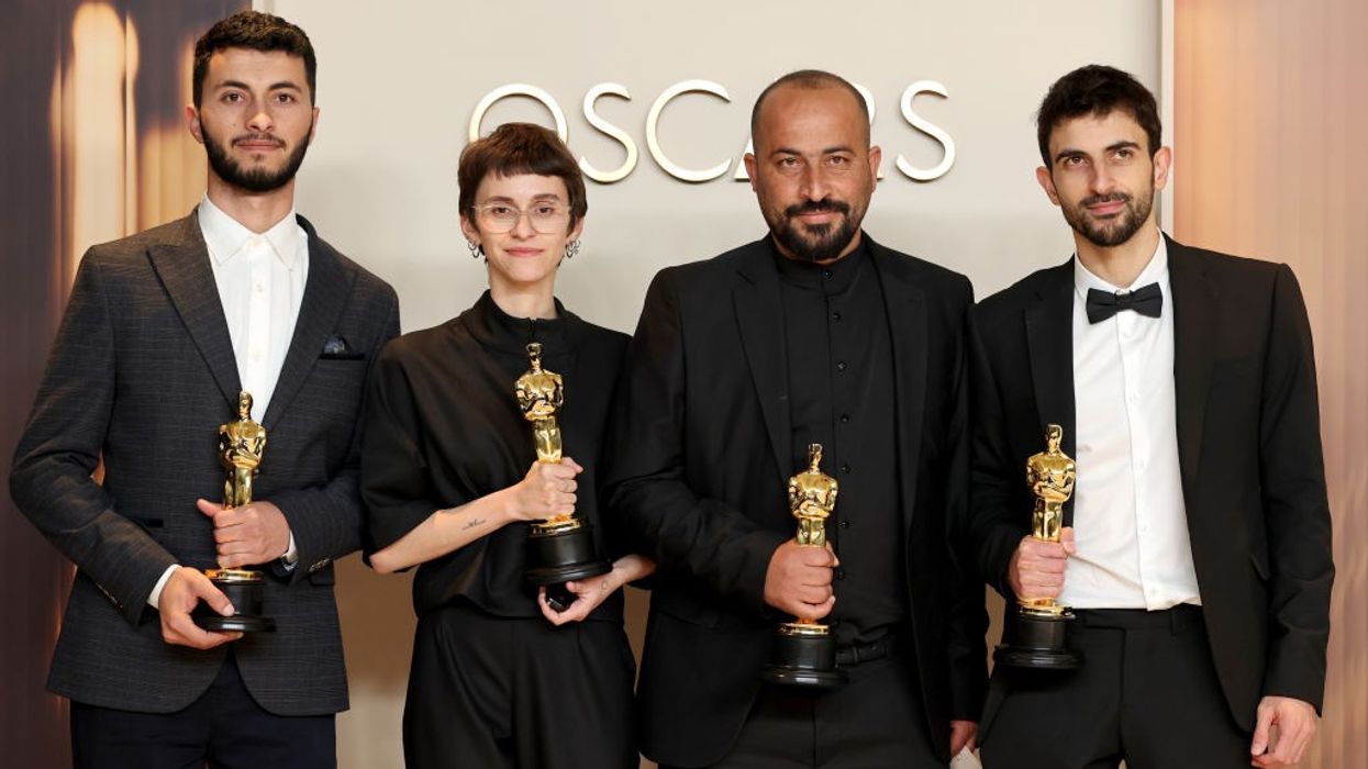 The four co-directors of 'No Other Land' hold their Oscars