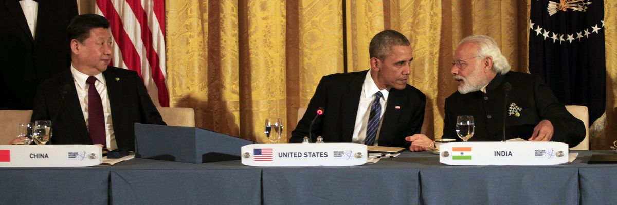 The leaders of China, the U.S., and India sit at a table.