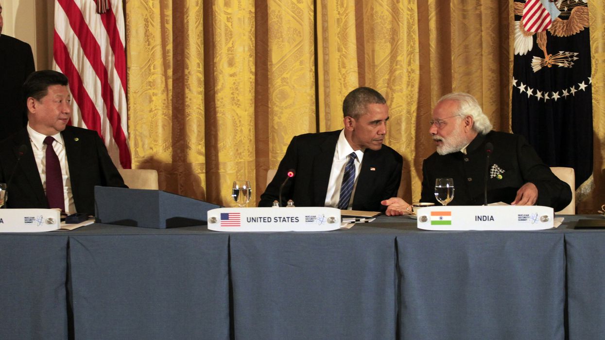 The leaders of China, the U.S., and India sit at a table.