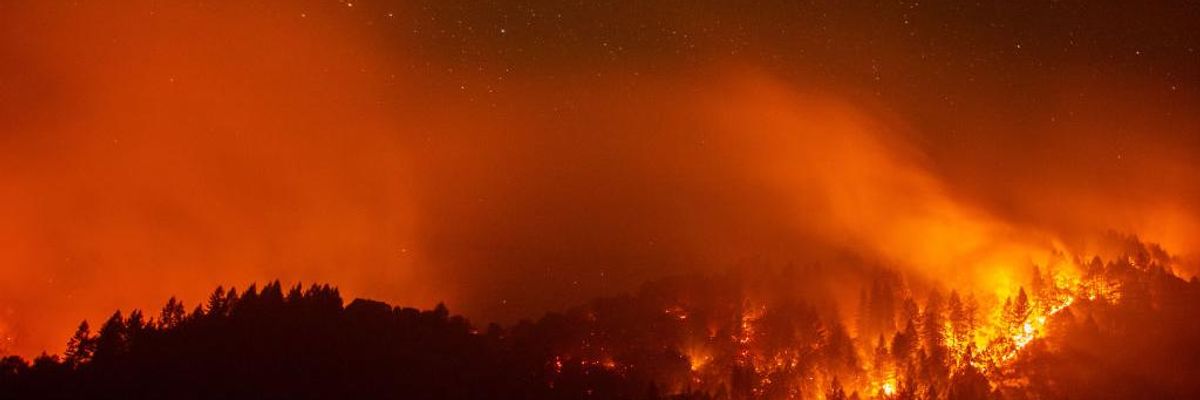 As Party of Climate Denial Meets, Wildfires Rage and Hurricanes Target Gulf Coast