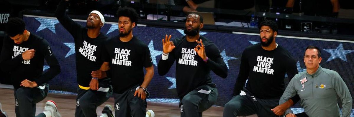 The Los Angeles Lakers kneel during the national anthem before the start of Game Five of the Western Conference First Round against the Portland Trail Blazers during the 2020 NBA Playoffs on August 29, 2020