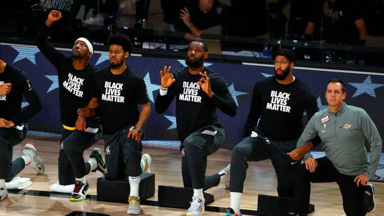 The Los Angeles Lakers kneel during the national anthem before the start of Game Five of the Western Conference First Round against the Portland Trail Blazers during the 2020 NBA Playoffs on August 29, 2020