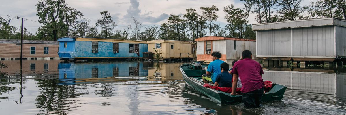 The Maldonado family travels by boat to their home after it flooded during Hurricane Ida on August 31, 2021 in Barataria, Louisiana.