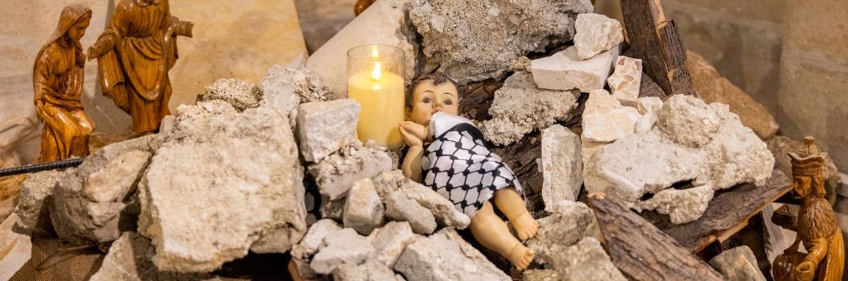 The Nativity scene shows baby Jesus wrapped in a keffiyeh and placed in a pile of rubble