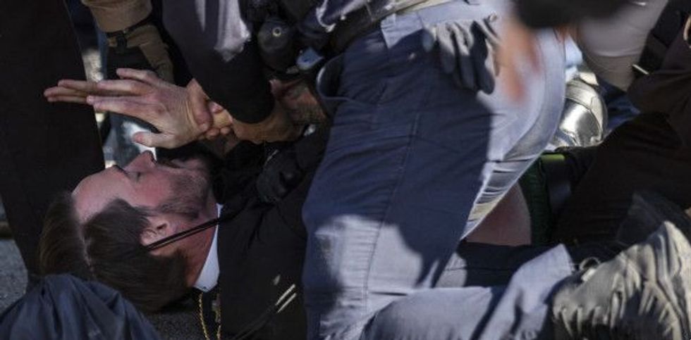 The Rev. Michael Woolf being assaulted at Broadview protest