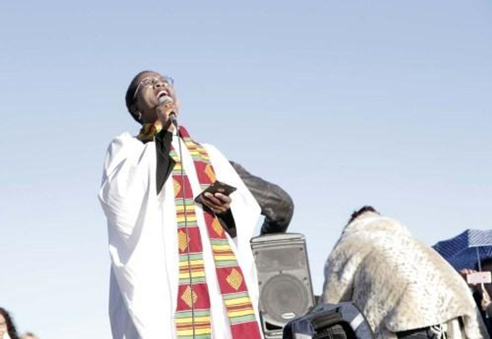 The Rev. Stephanie Spellers, canon to the presiding bishop for evangelism and reconciliation lead the 500 interfaith witnesses in singing