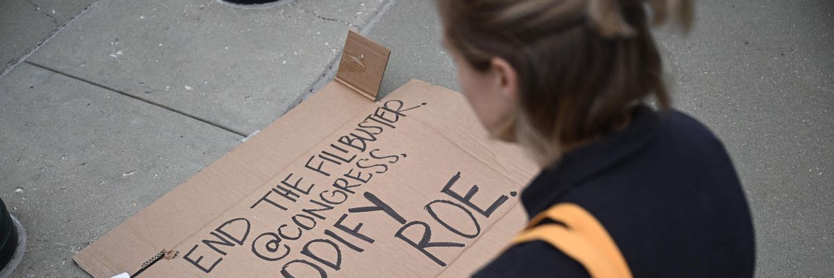The sign reads "End the filibuster, Congress... Codify Roe"
