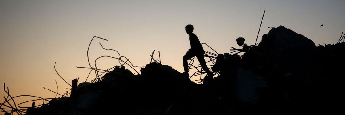 The silhouette of a Gazan child playing amid the rubble