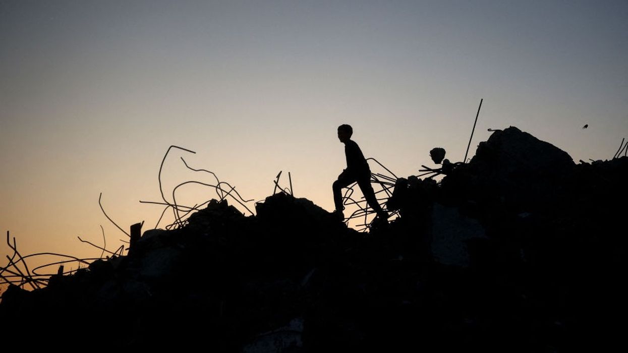 The silhouette of a Gazan child playing amid the rubble
