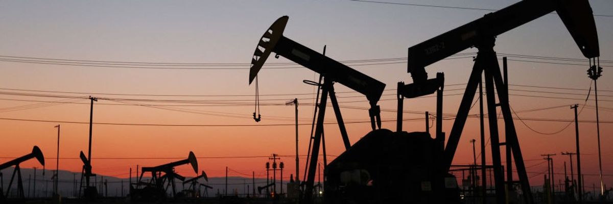 The sun sets beyond pumpjacks in the Belridge oil field on November 3, 2021 near McKittrick, California.
