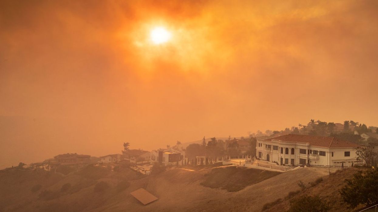 The sun shines orange through wildfire smoke.