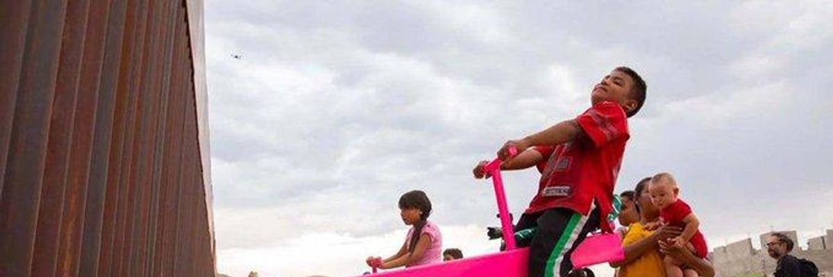 In Joyful Act of Resistance, Pink Seesaws Installed at Border Fence