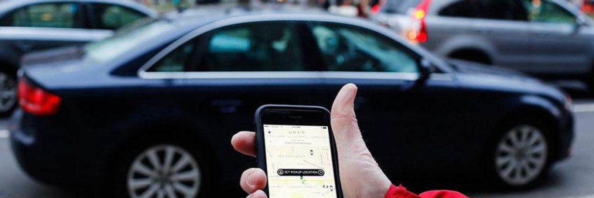 The Uber phone app is shown as cars drive by in Washington, D.C.