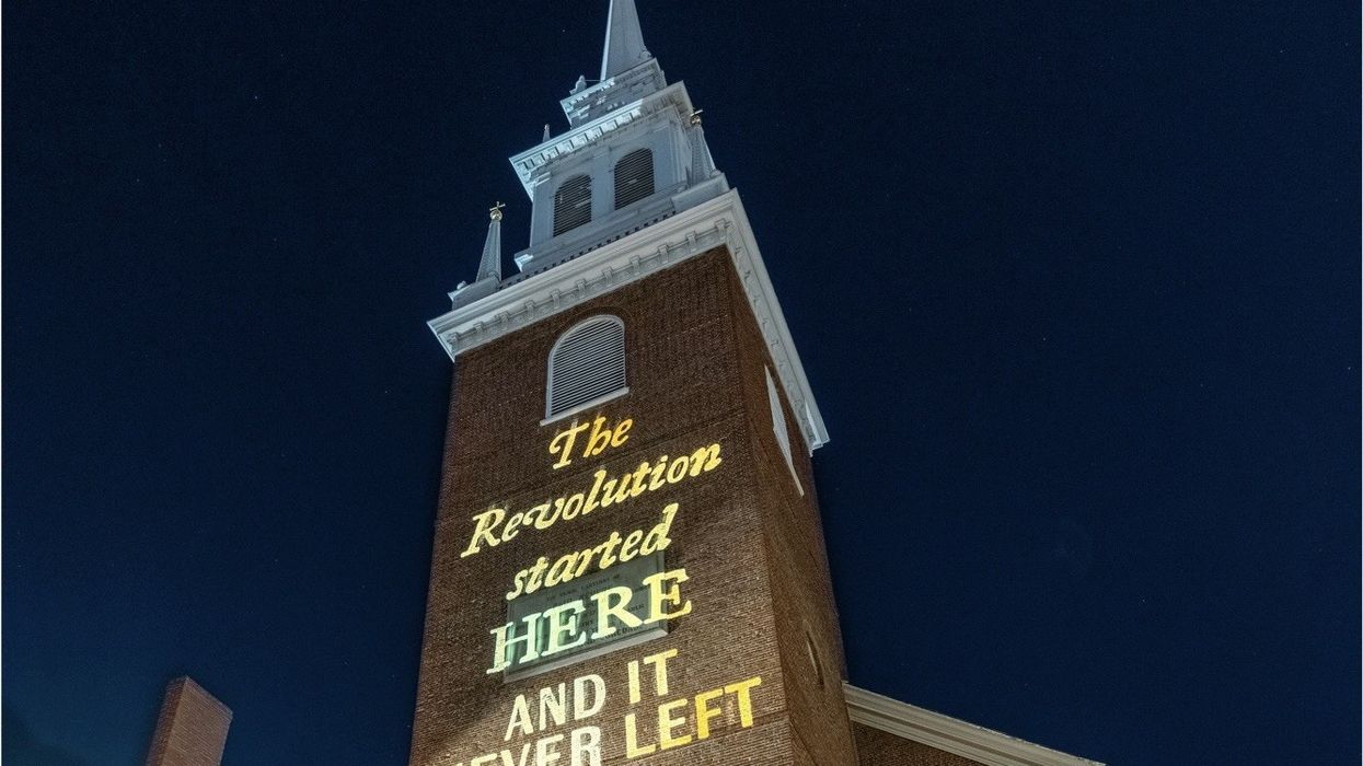 The words "The Revolution started here and it never left" are projected on Boston's Old North Church.