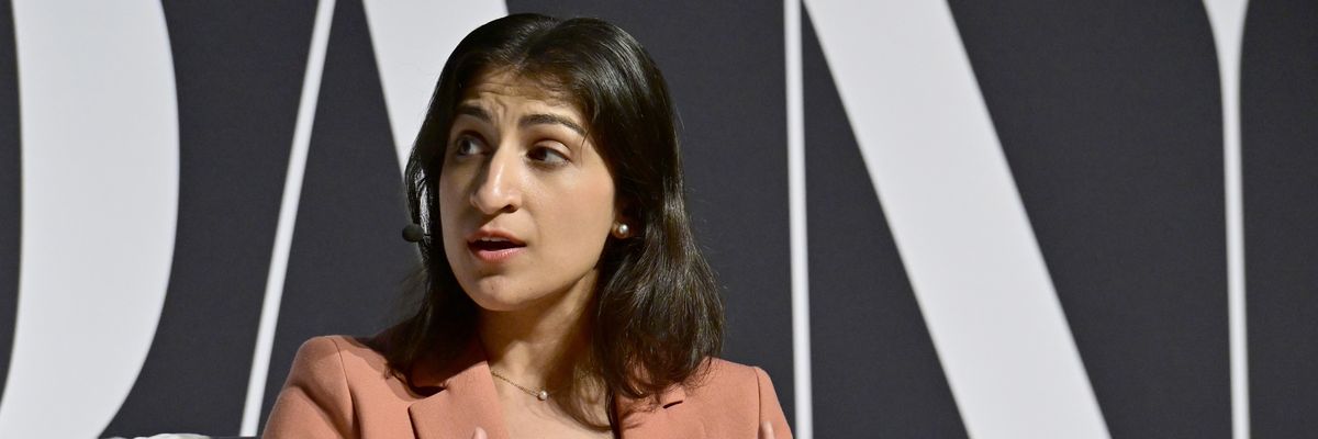 Then-Federal Trade Commission Chair Lina Khan in a pink suit sitting in a chair