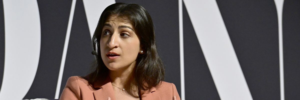 Then-Federal Trade Commission Chair Lina Khan in a pink suit sitting in a chair