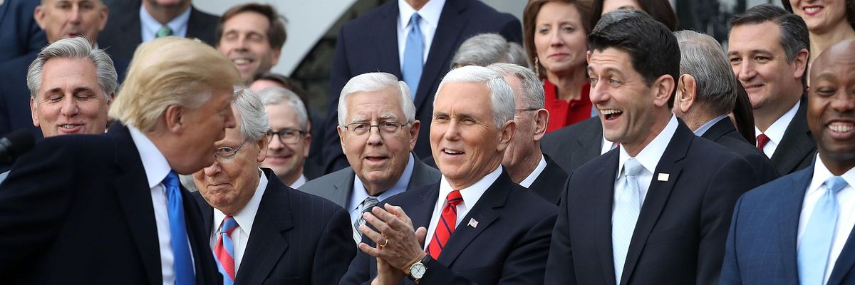 Then-President Donald Trump jokes with Republican lawmakers