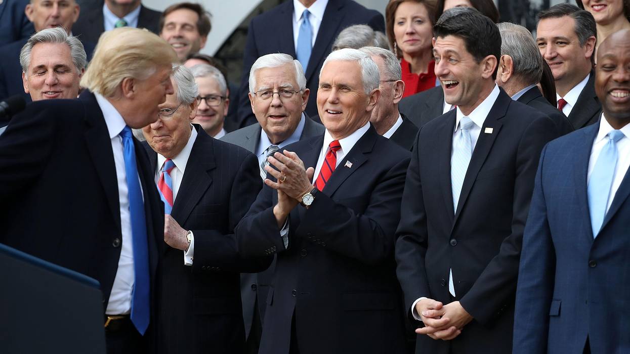 Then-President Donald Trump jokes with Republican lawmakers