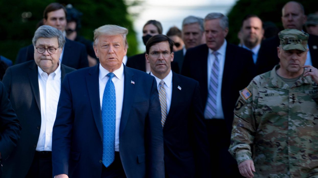 Then-President Donald Trump walks with U.S. Attorney General William Barr (L), Secretary of Defense Mark T. Esper (C), Chairman of the Joint Chiefs of Staff Mark A. Milley (R), and others from the White House to visit St. John's Church after the area was cleared of people protesting the death of George Floyd June 1, 2020, in Washington, DC. (Photo: Brendan Smialowski/AFP via Getty Images)