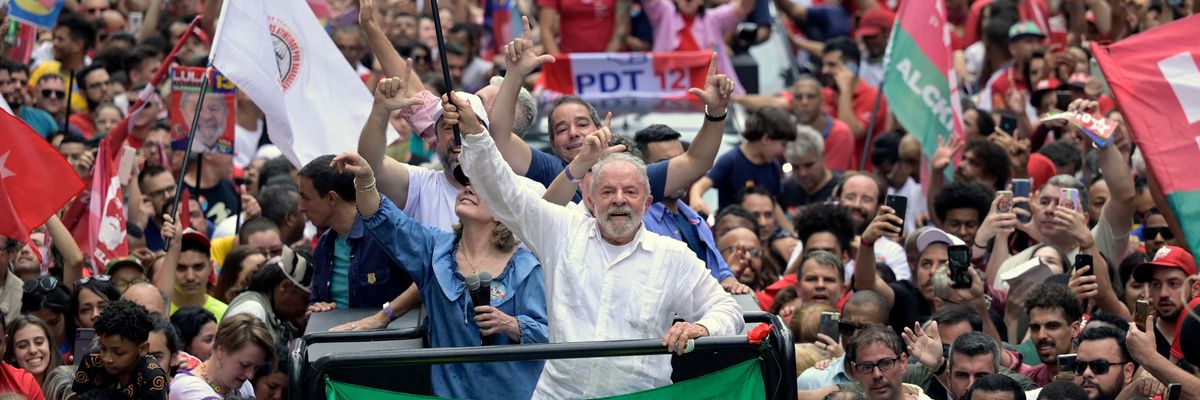 Then presidential candidate Luiz Inacio "Lula" da Silva waves a national flag during a campaign rally in Belo Horizonte, Minas Gerais state, Brazil on October 9, 2022.